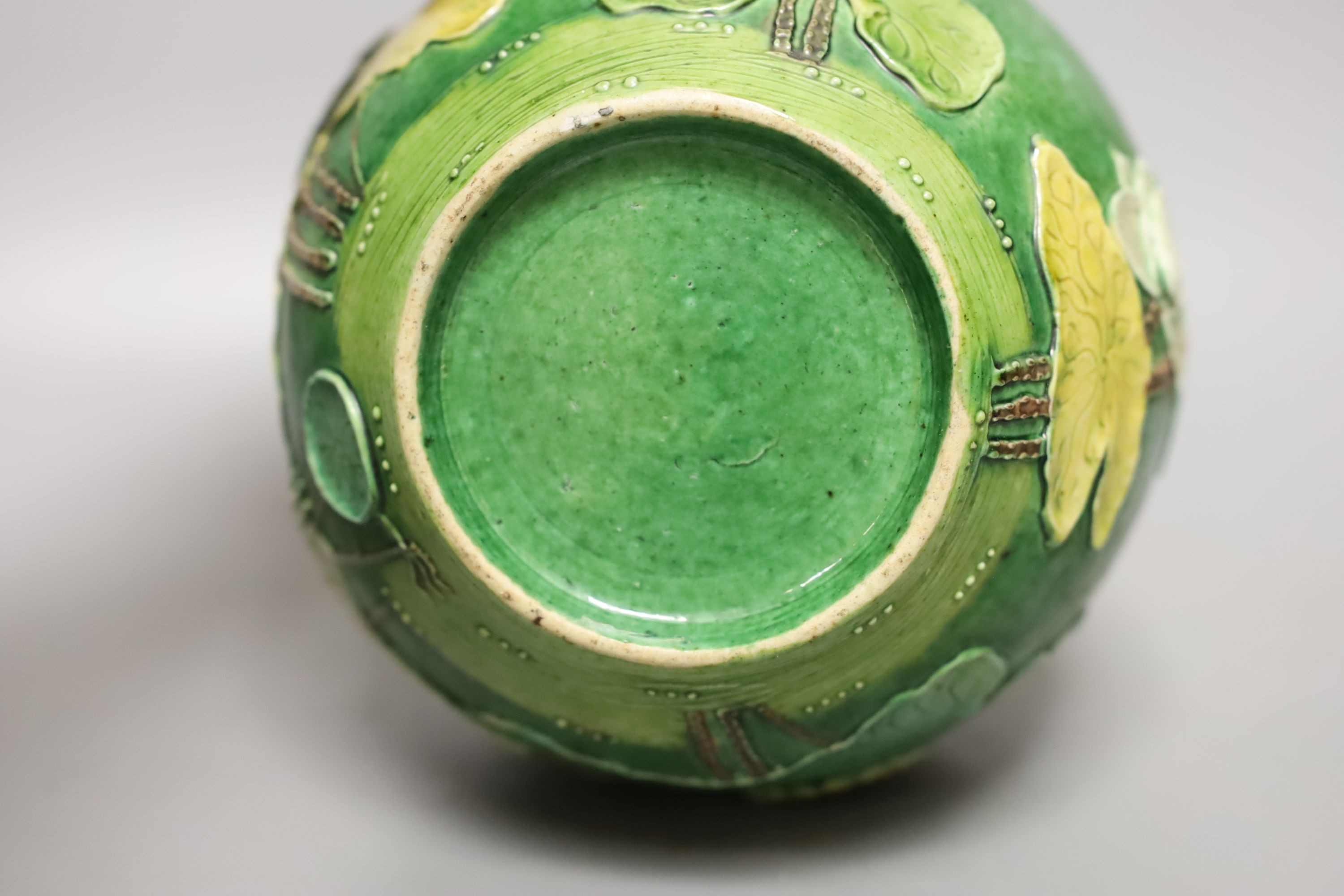 An early 20th century Chinese green-glazed ‘lotus’ jar and cover 18cm